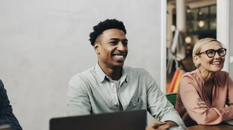 image of man smiling in a meeting