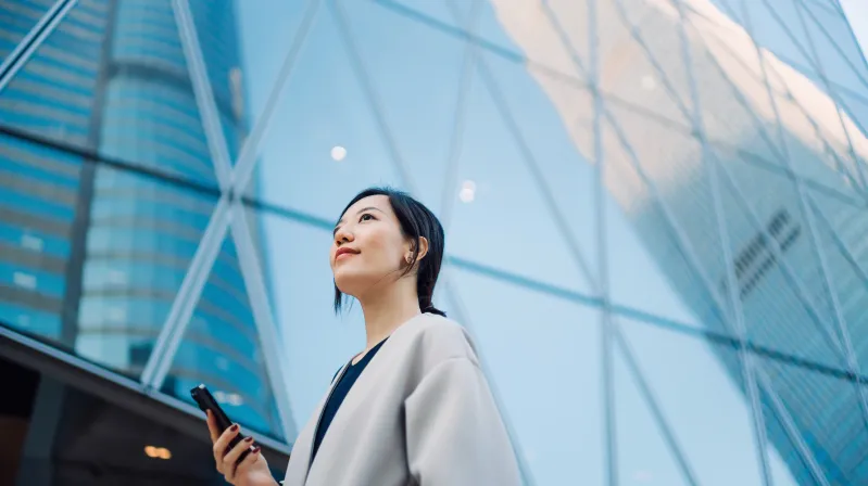 Image of a girl looking up with phone in her hand
