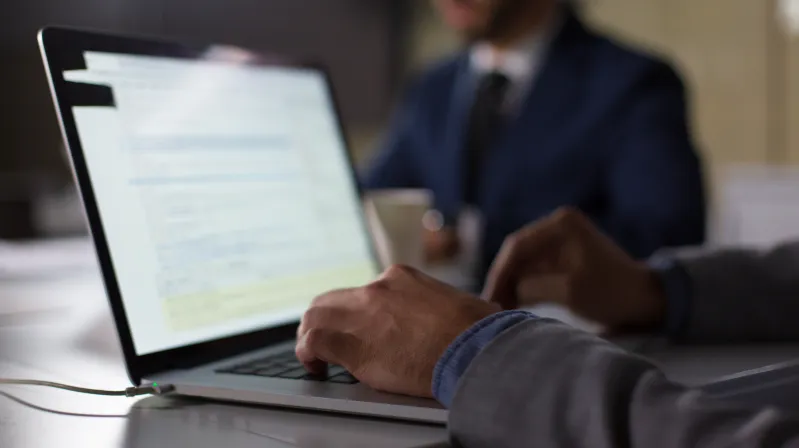 man typing on the computer in an office