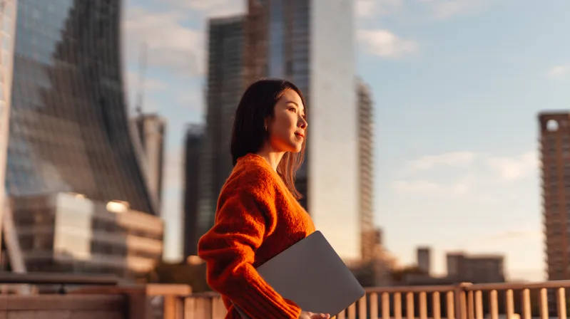 Picture of a lady walking with laptop