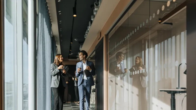 coworkers conversing in a hallway