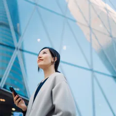 Image of a girl looking up with phone in her hand