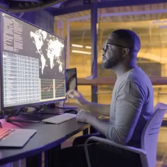 Image of a man looking at the large screen