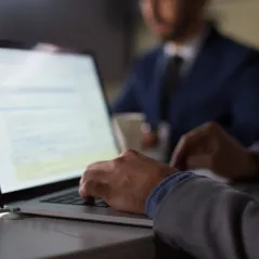 man typing on the computer in an office
