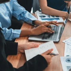 Image of people typing on laptop