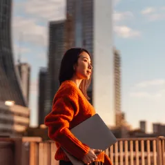 Picture of a lady walking with laptop
