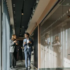 coworkers conversing in a hallway
